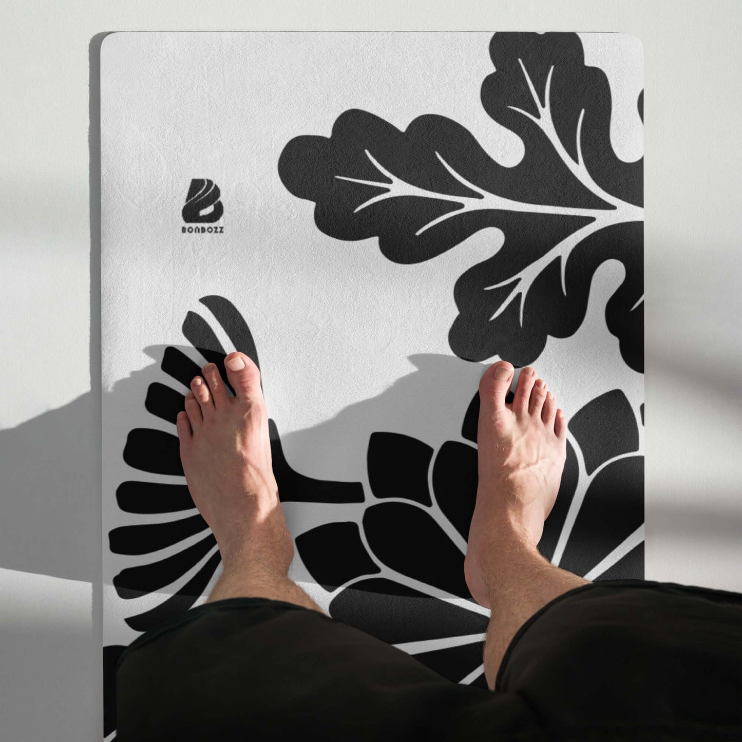 Yoga-Matte N°0 with floral design, showing feet on the mat, emphasizing stability and comfort with a non-slip rubber base.