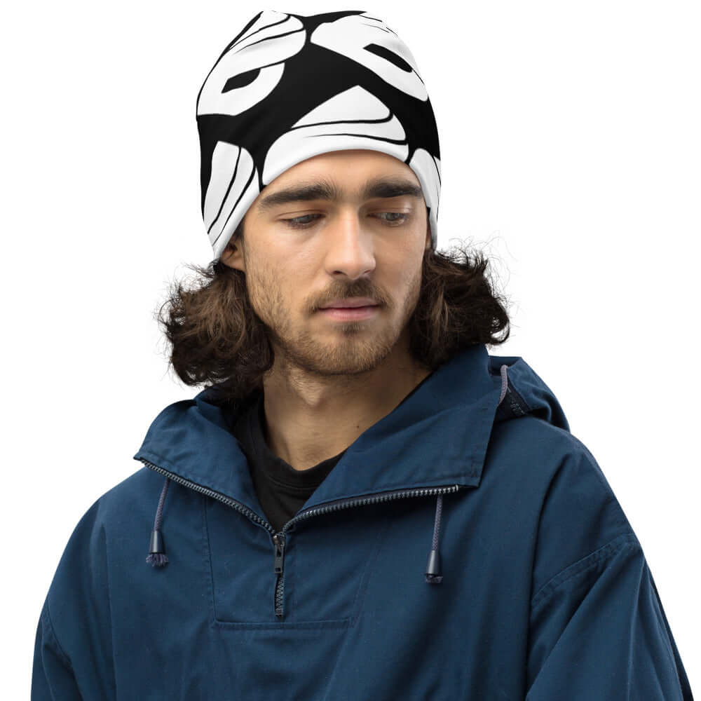 Man wearing Allover-Beanie N°0 in black and white pattern, warm and stylish for cold weather, polyester blend, fits comfortably, casual look.