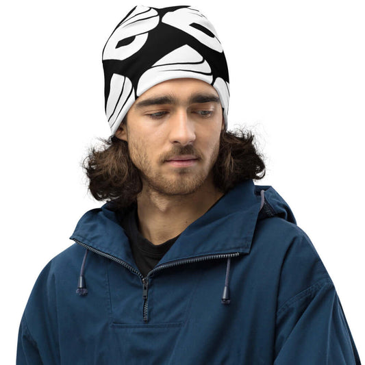 Man wearing Allover-Beanie N°0 in black and white pattern, warm and stylish for cold weather, polyester blend, fits comfortably, casual look.