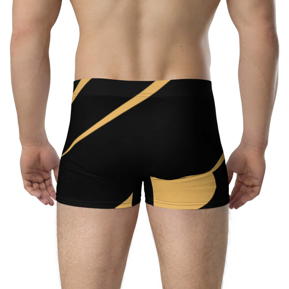 Back view of man wearing Boxer-Briefs N°2 with abstract black and gold design, showcasing comfortable, stretchable material.