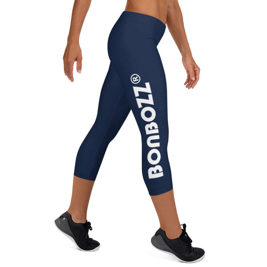 Woman wearing Capri-Leggings N°0 in navy with Bonbozz logo, showcasing four-way stretch and microfiber comfort, side view.