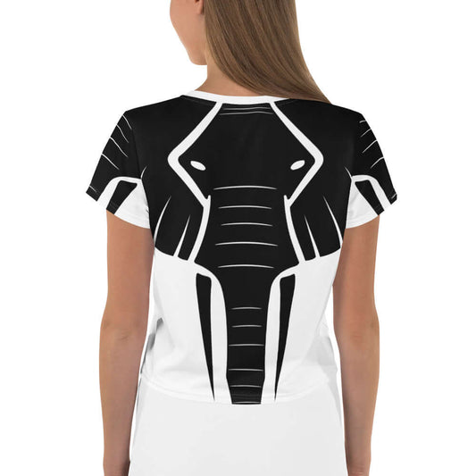 Woman wearing Allover-Crop-T-Shirt N°0 with unique elephant design on back view. High-quality jersey and four-way stretch fabric.