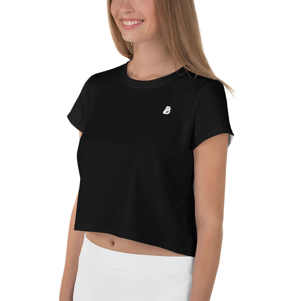Woman wearing Allover-Crop-T-Shirt N°2 in black with white logo, stylish short-sleeve design.