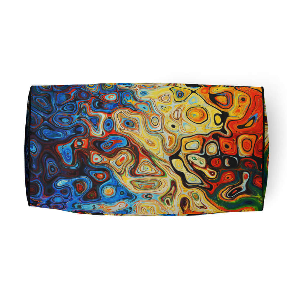 Colorful abstract design on a beach towel with swirls of blue, red, and yellow.