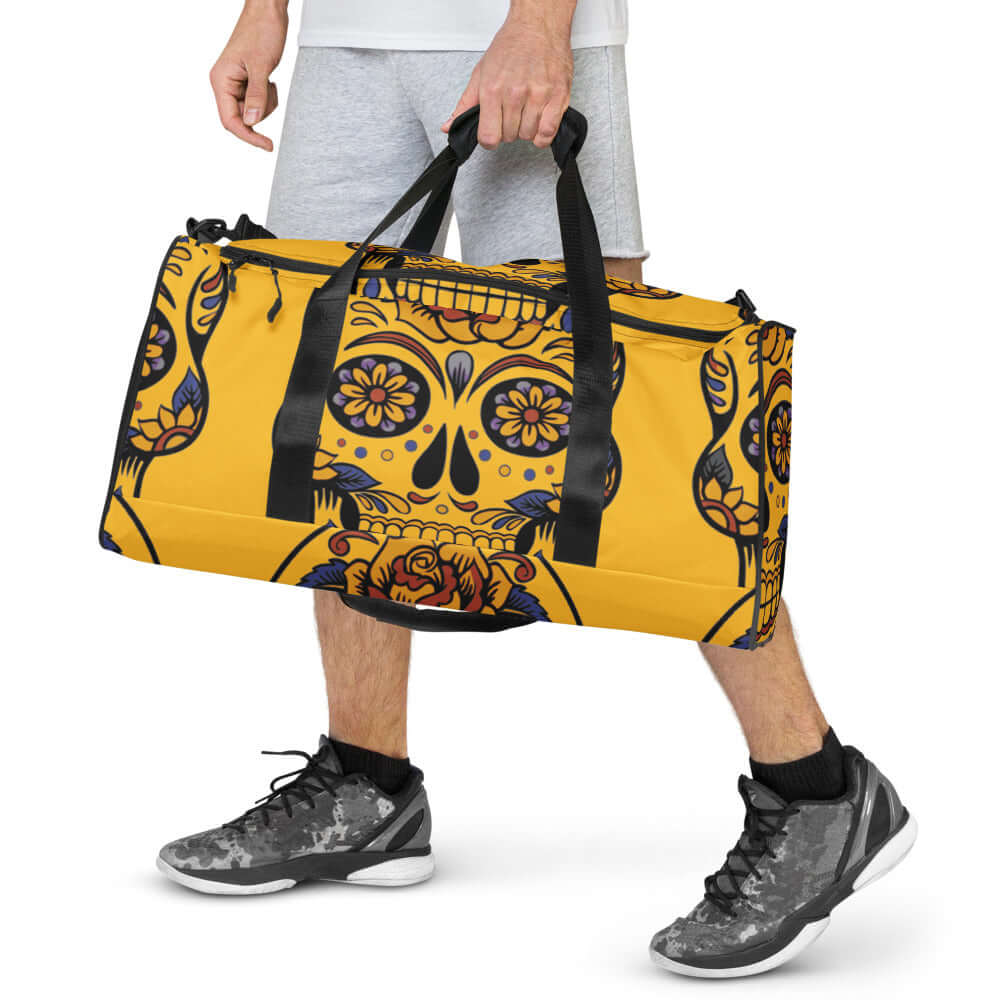 Man carrying Weekender N°1 with sugar skull design, ideal for travel, errands, or gym. Spacious with adjustable padded shoulder straps.