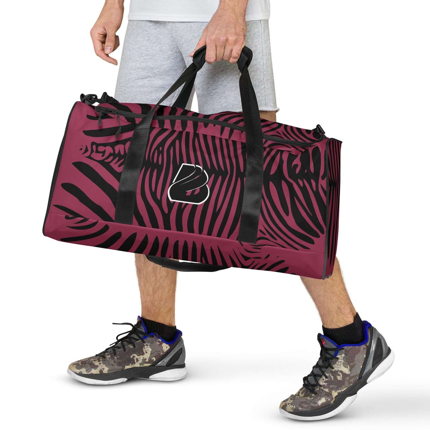 Person carrying a stylish Weekender N°23 with black and red design, perfect for travel and daily use, featuring adjustable straps and ample space.