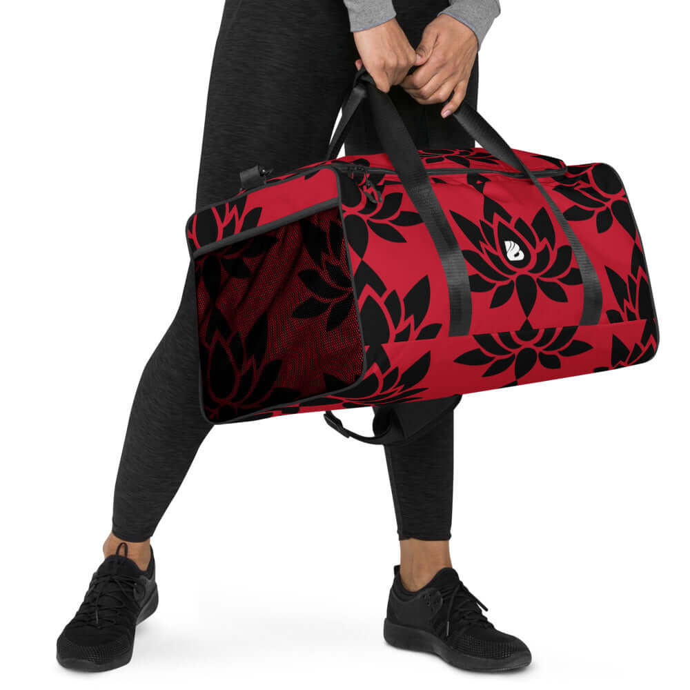 Person carrying a floral red Weekender N°6 bag with adjustable straps for travel, errands, or gym.