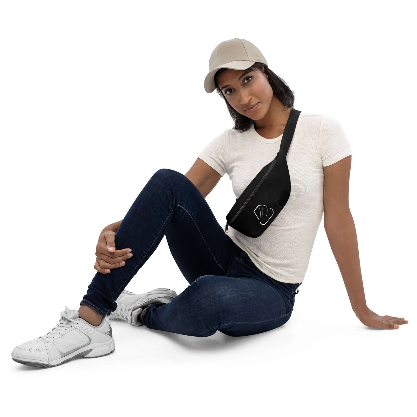 Woman wearing Gürteltasche N°24 black belt bag sitting on floor in casual outfit.