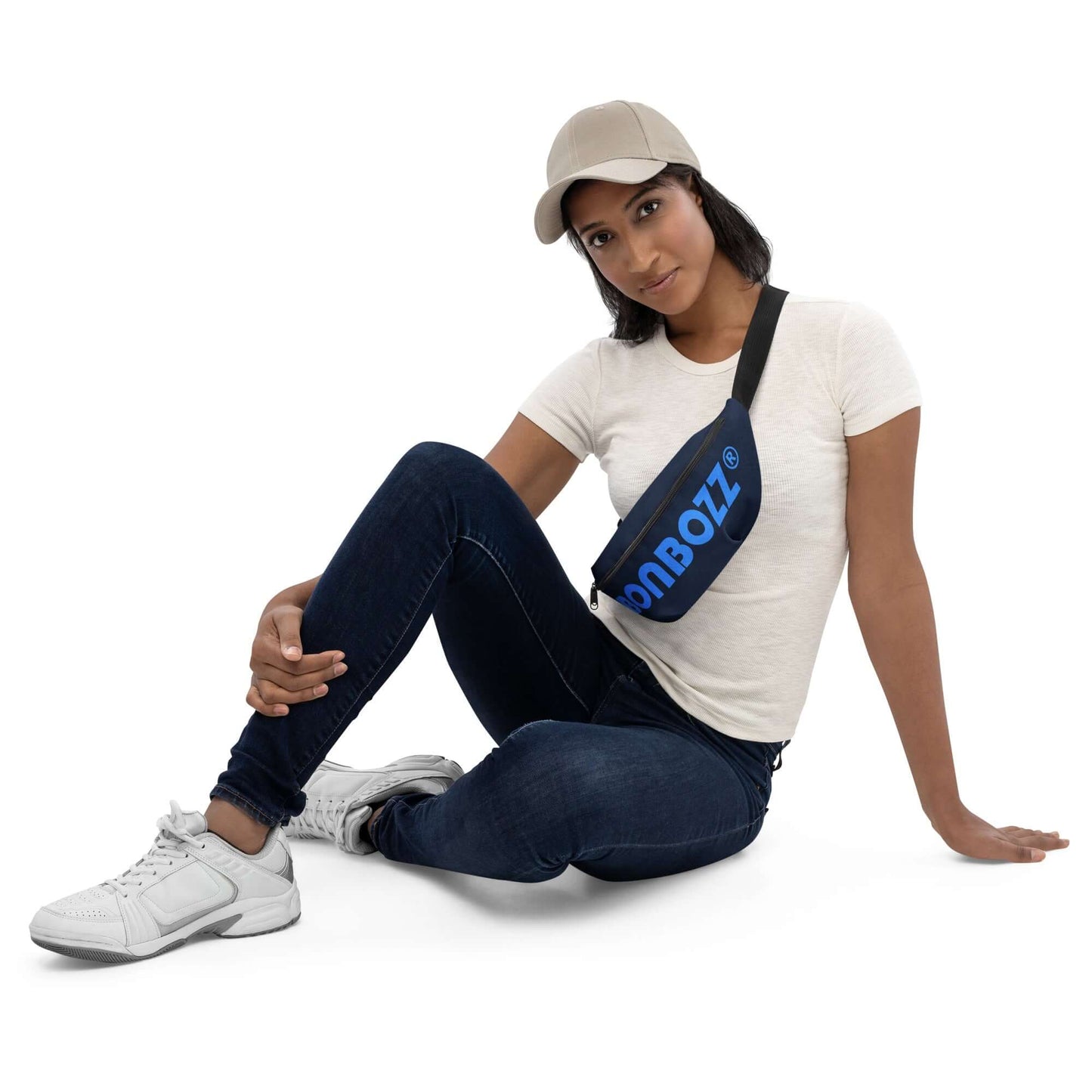 Model wearing Gürteltasche N°26, blue adjustable belt bag, ideal for festivals and travel, sitting casually in stylish jeans.
