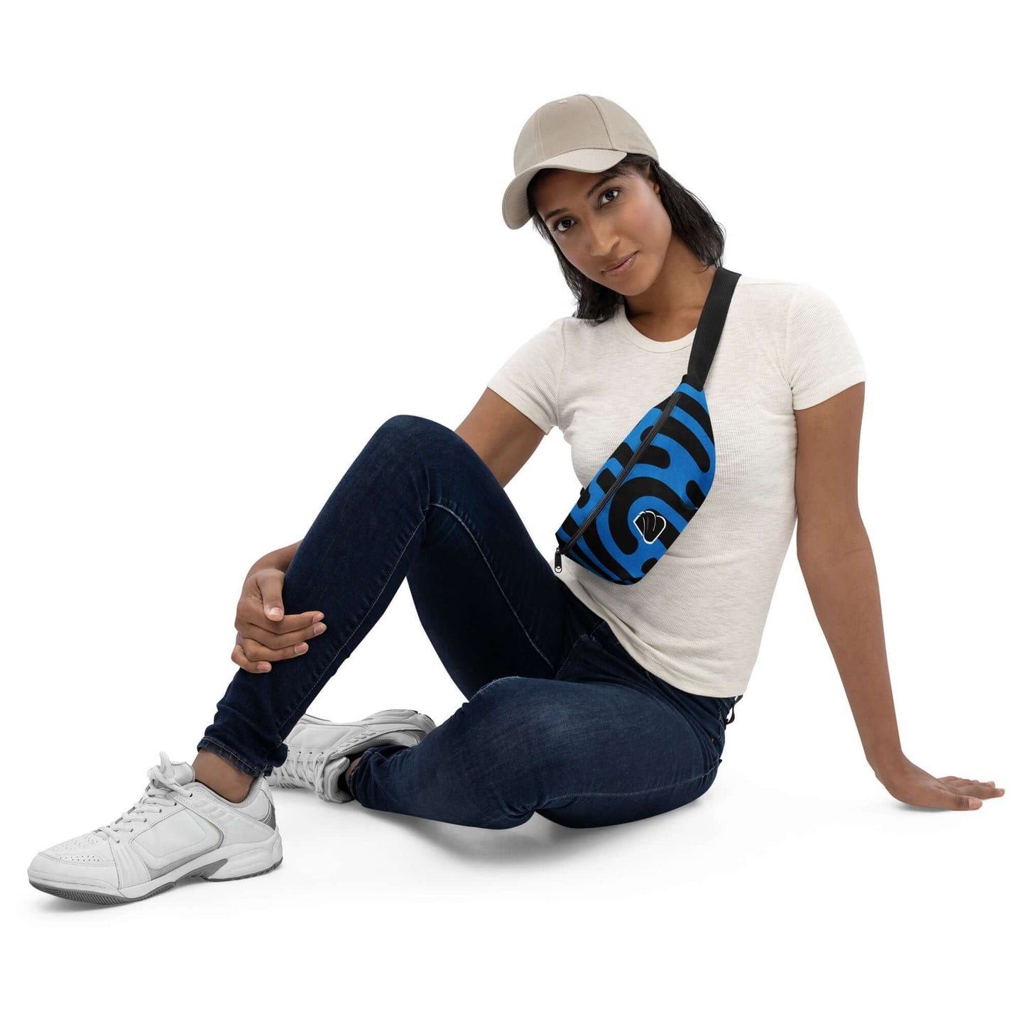 Model wearing Gürteltasche N°27 in blue, seated casually, showcasing versatility and style.