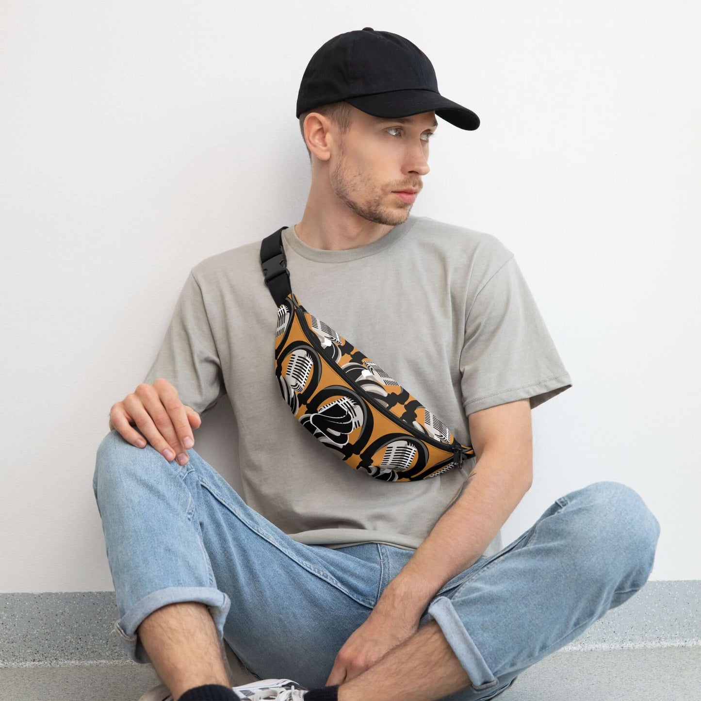 Man wearing Gürteltasche N°28, a stylish adjustable festival belt bag with floral print, sitting casually in jeans and t-shirt.