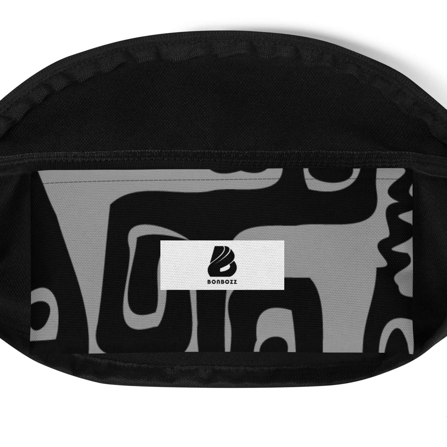 Open black Gürteltasche N°22 showing interior with abstract black and white pattern and logo.