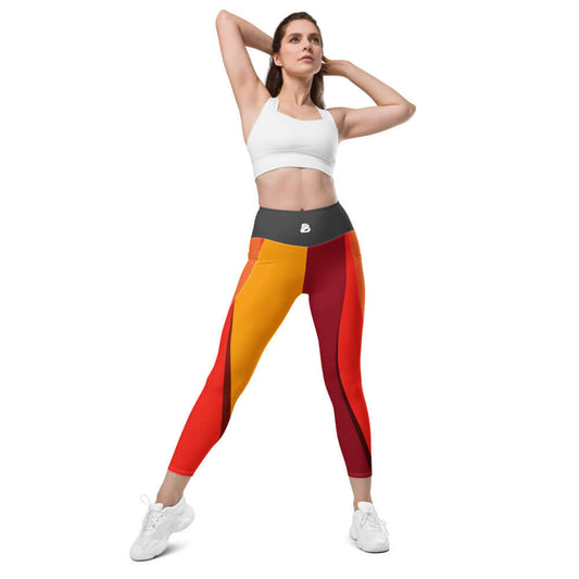 Woman wearing colorful high-waisted leggings in a pose, showcasing Leggings mit Taschen N°0 with practical side pockets.