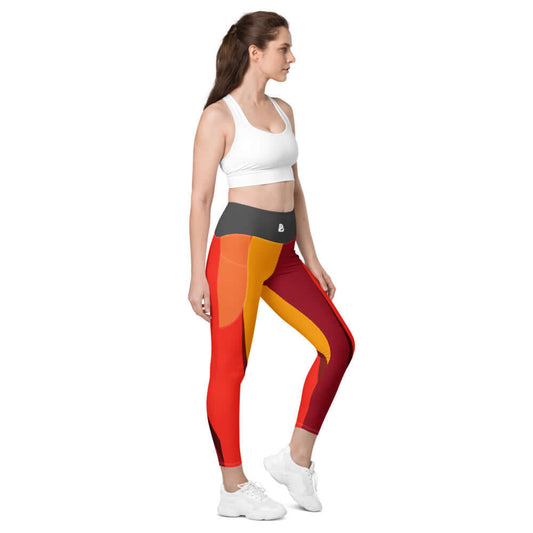 Alt Tag: Woman wearing Leggings mit Taschen N°0 with side pockets, high-waisted fit, and vibrant red and orange colors.
