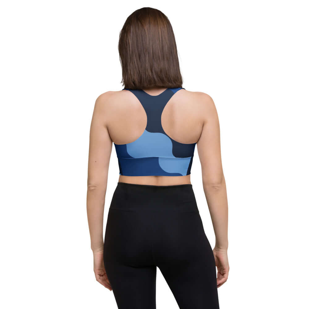 Back view of woman wearing Longline-Sport-BH N°1 for athletic activities, showcasing support and style in blue design.