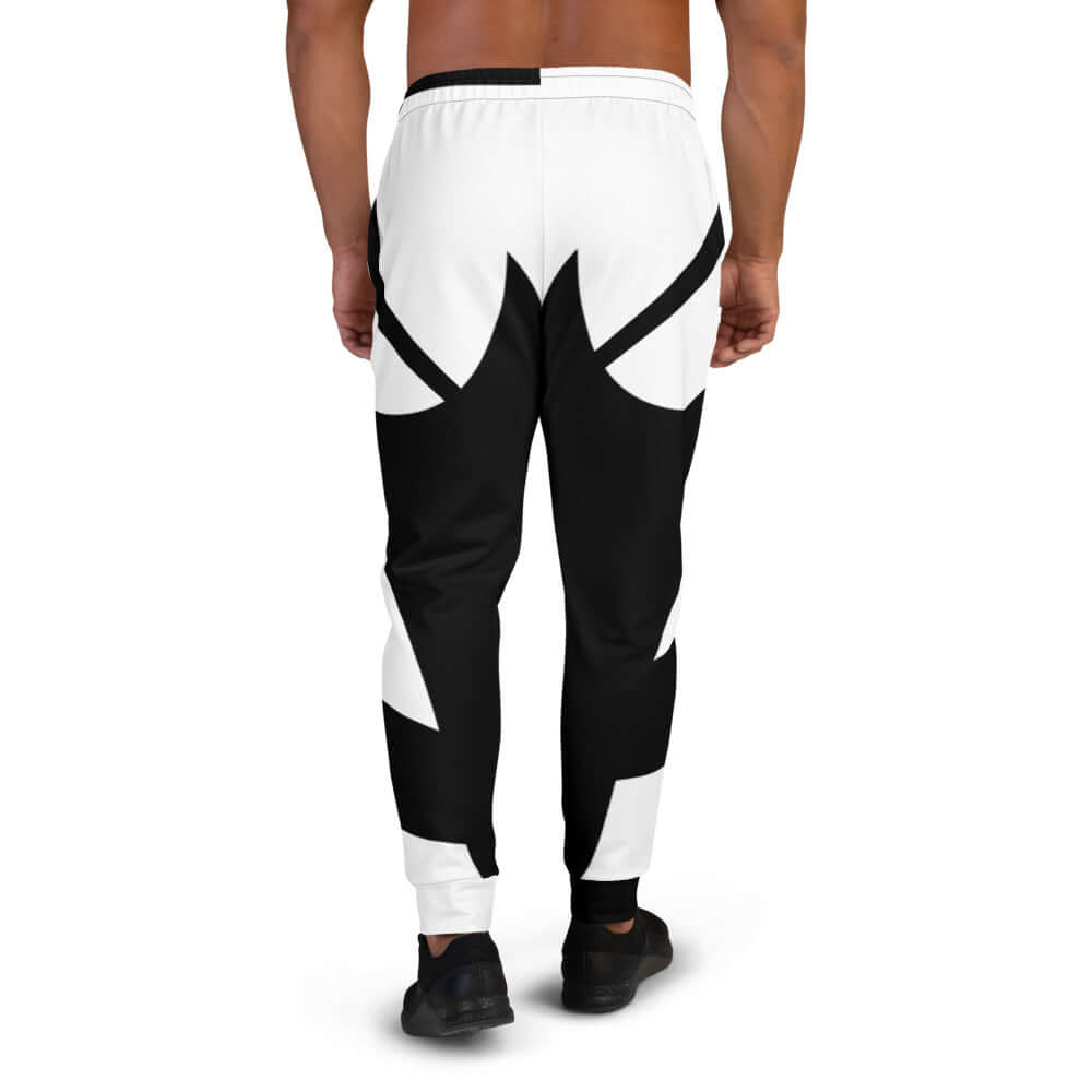 Herren-Jogginghose N°1 in black and white worn by a model, showcasing rear view of soft cotton-blend jogging pants for versatile wear.