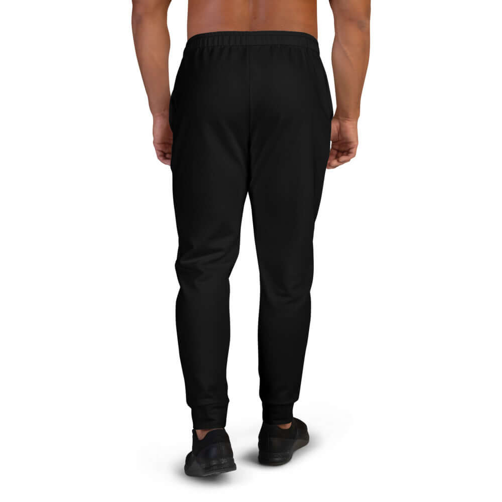 Back view of Herren-Jogginghose N°4 in black, featuring a soft cotton blend and brushed fleece interior, perfect for jogging or relaxing.