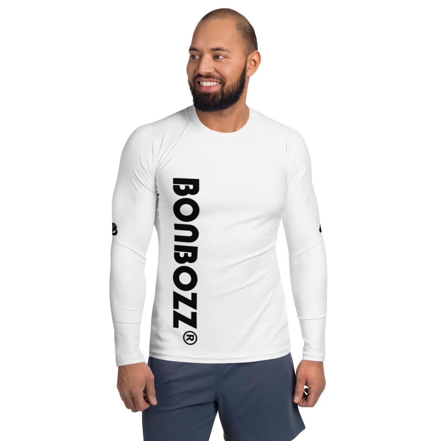 Smiling man wearing white Herren-Rash-Guard N°28 with black pants, outdoor sports wear for sun and weather protection.