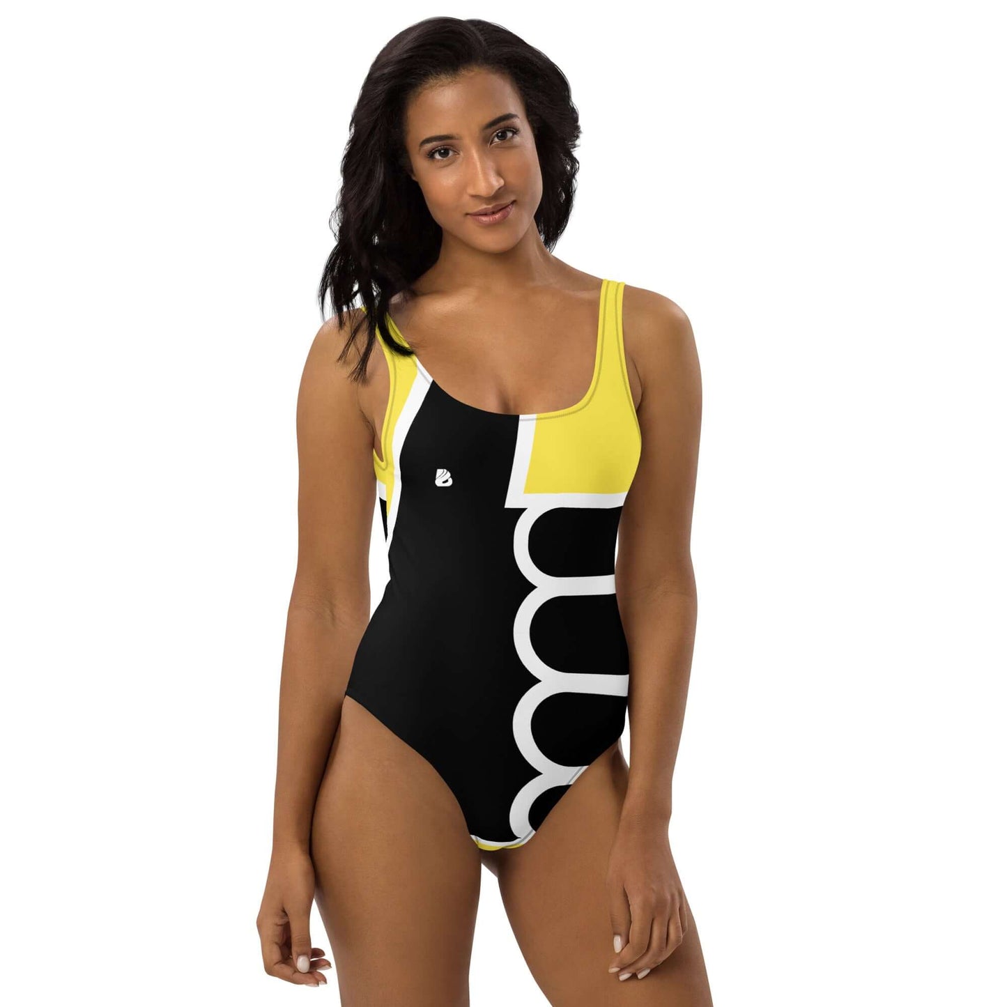 Model wearing Einteiliger Badeanzug N°19 showcasing flattering yellow and black design at the seaside or pool.