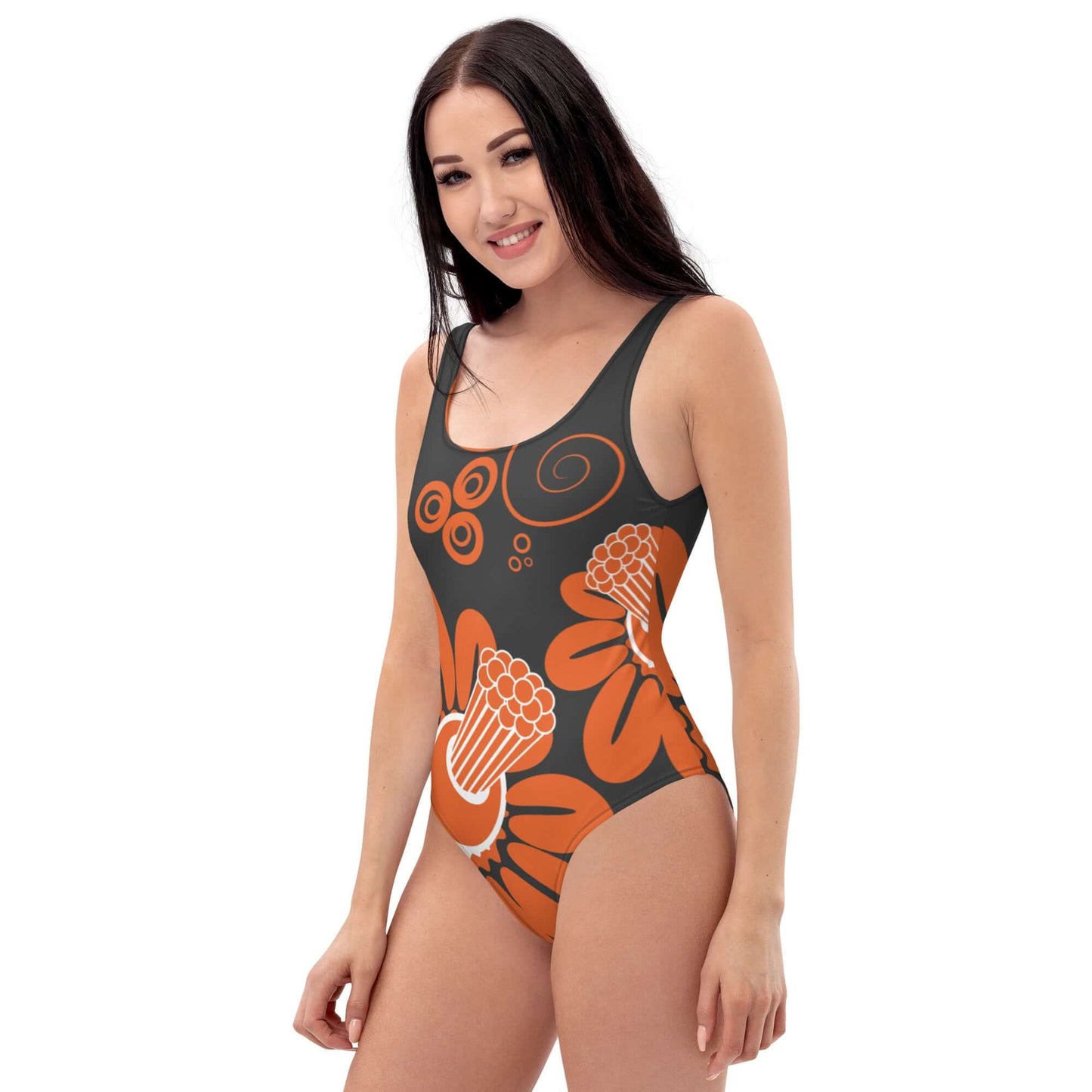 Woman wearing Einteiliger Badeanzug N°16 with floral design, showcasing beach fashion in a flattering swimsuit style.