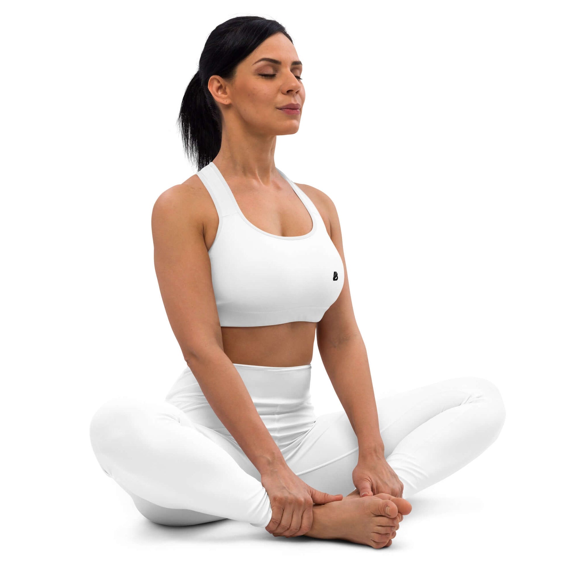 Woman practicing yoga in Gepolsterter Sport-BH N°4, white workout attire, seated in a meditation pose.