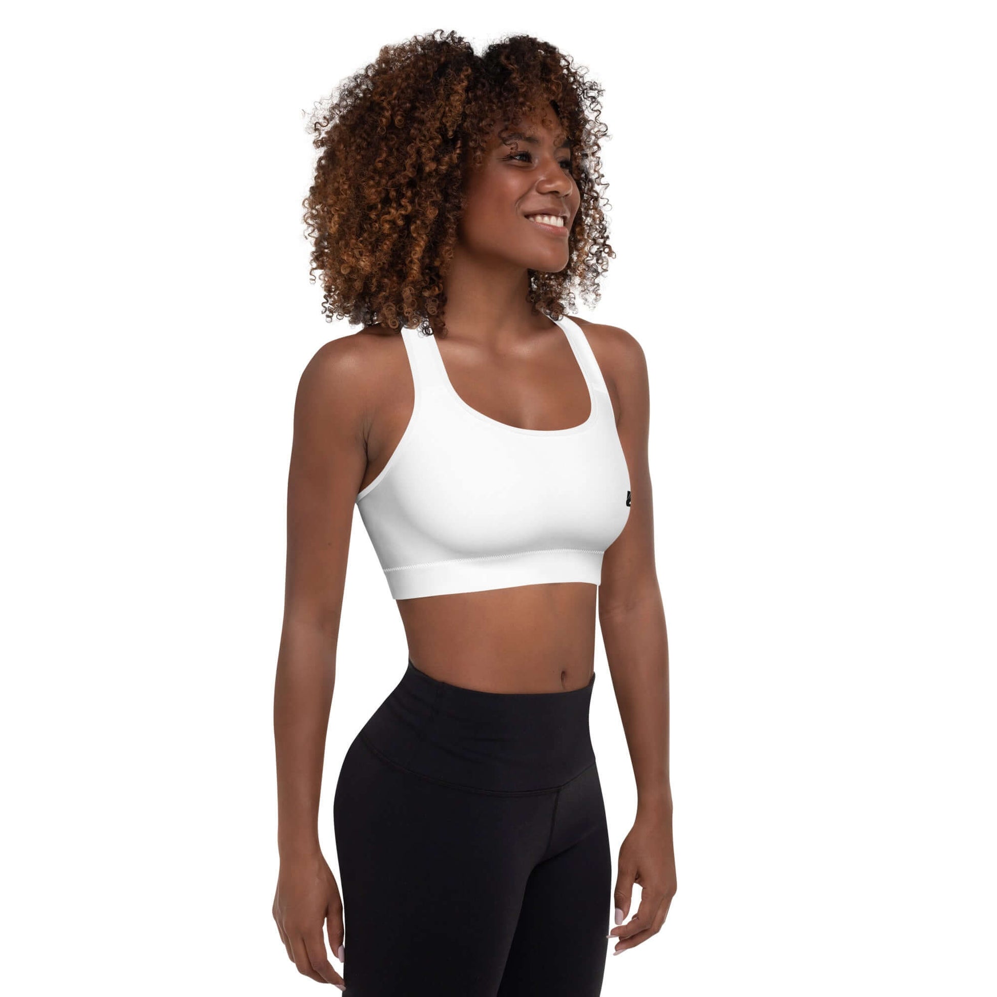 Woman wearing white Gepolsterter Sport-BH N°4 designed for comfort and support during workouts.