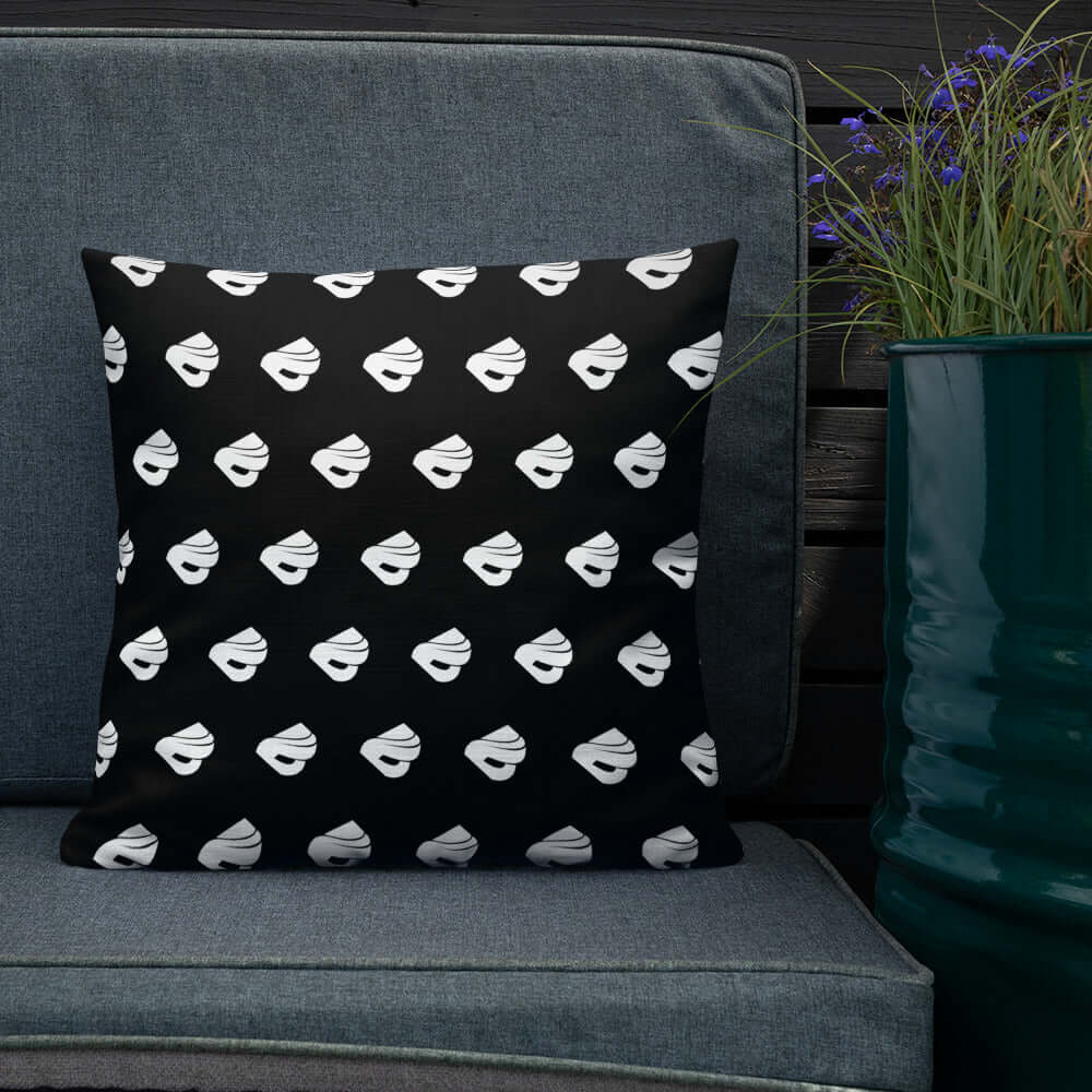 Premium-Kissen N°0 with black and white design on a dark sofa, enhancing home decor with luxury and style.