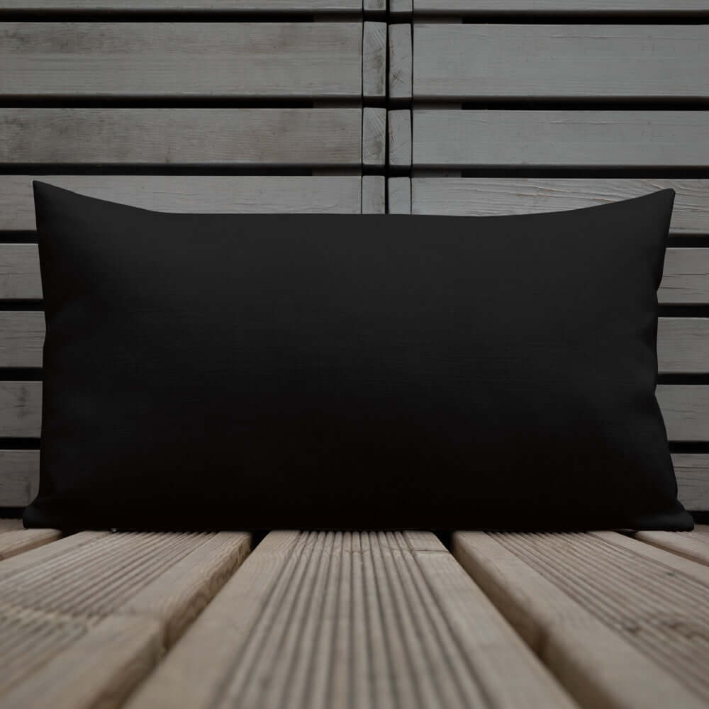 Premium-Kissen N°0 black cushion on wooden surface, luxurious home decor accent
