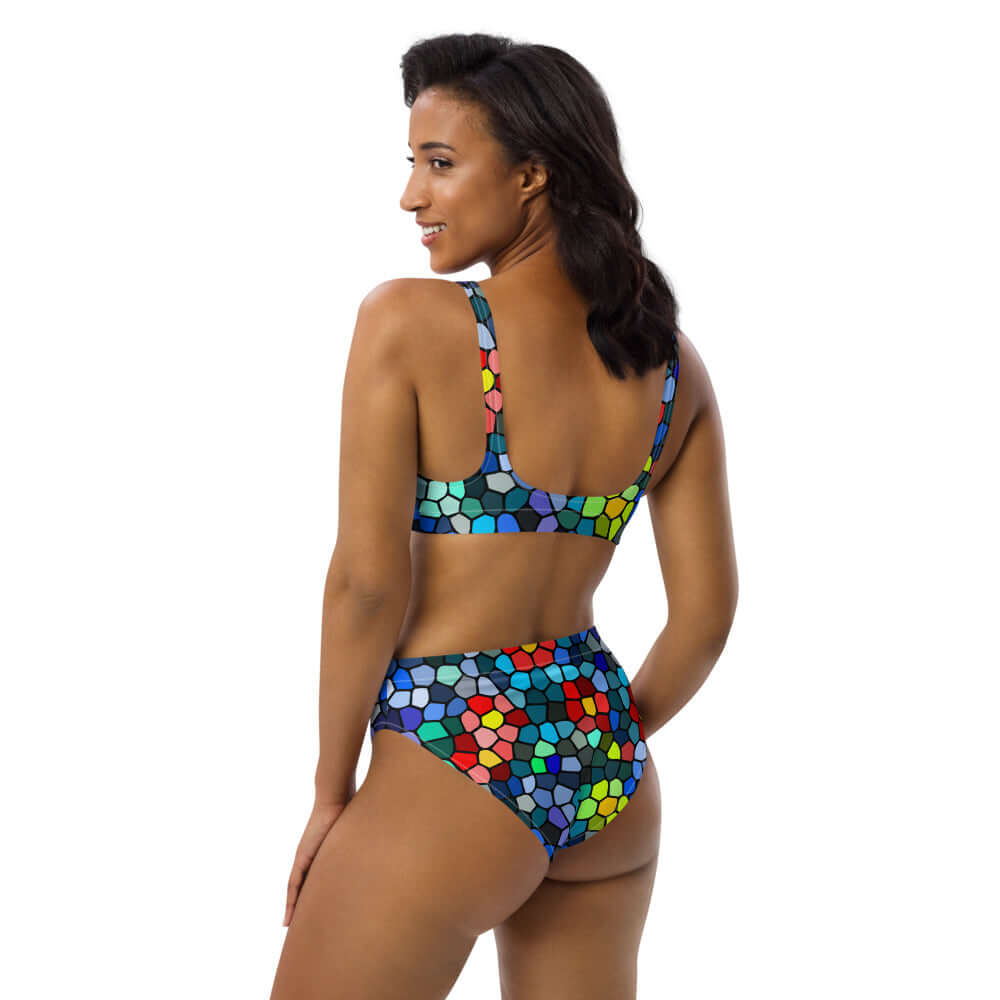 Woman wearing colorful patterned High Waist Bikini N°0 from the back, featuring sustainable recycled materials for a comfortable beach day.