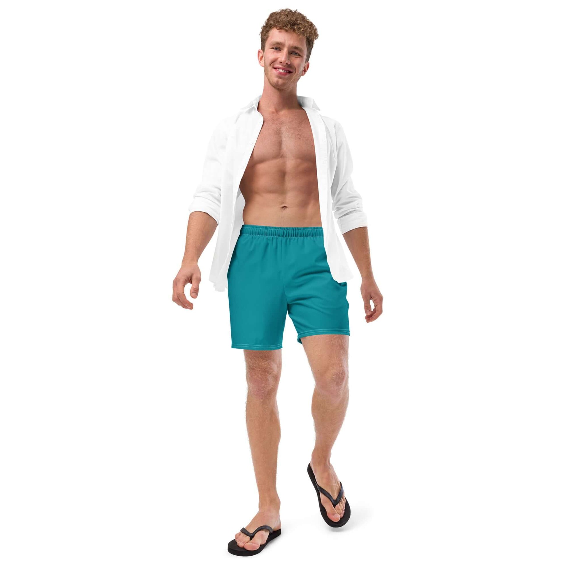 Herren-Badehosen N°10 in teal being worn by a model, showcasing quick-dry, breathable fabric with pockets and silky lining for summer.