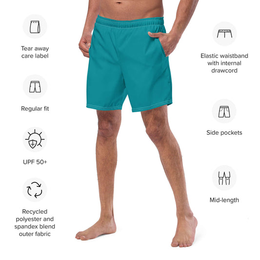 Model wearing Herren-Badehosen N°10, mid-length teal swim trunks with elastic waistband and side pockets, ideal for summer activities.