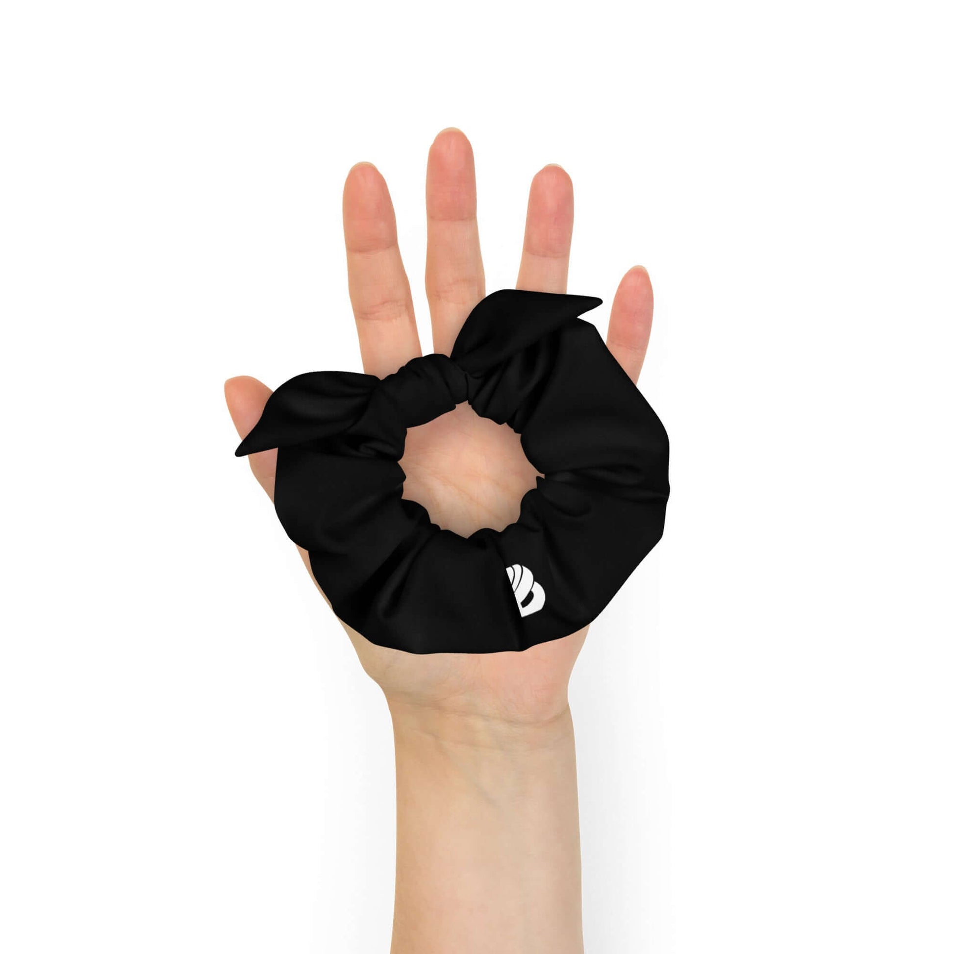 Hand holding a black Scrunchie N°2 made of leftover polyester and elastane, stylish and trendy hair accessory, one size fits all.