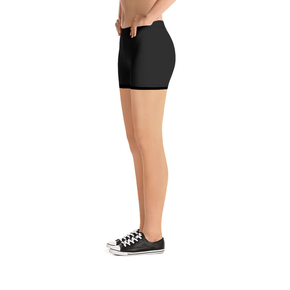 Side view of model wearing black Shorts N°0, featuring four-way stretch and smooth microfibre, ideal for versatility and comfort.