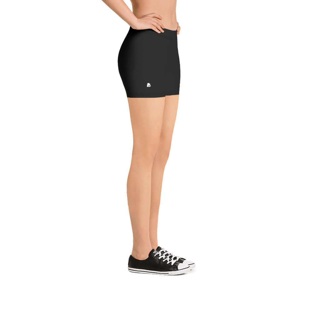 Side view of model wearing black Shorts N°0, showing comfort and style, perfect fit with four-way stretch fabric.