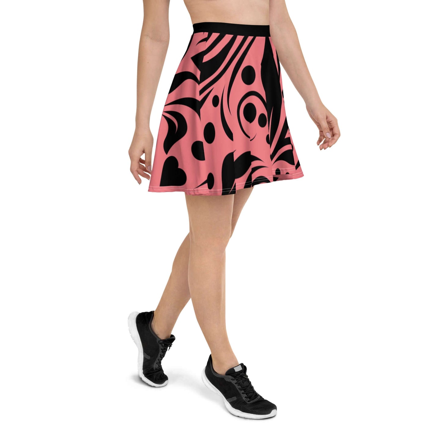 Person wearing Skater-Rock N°9 with pink and black abstract pattern, mid-thigh length skirt with elastic waistband for comfortable fit.