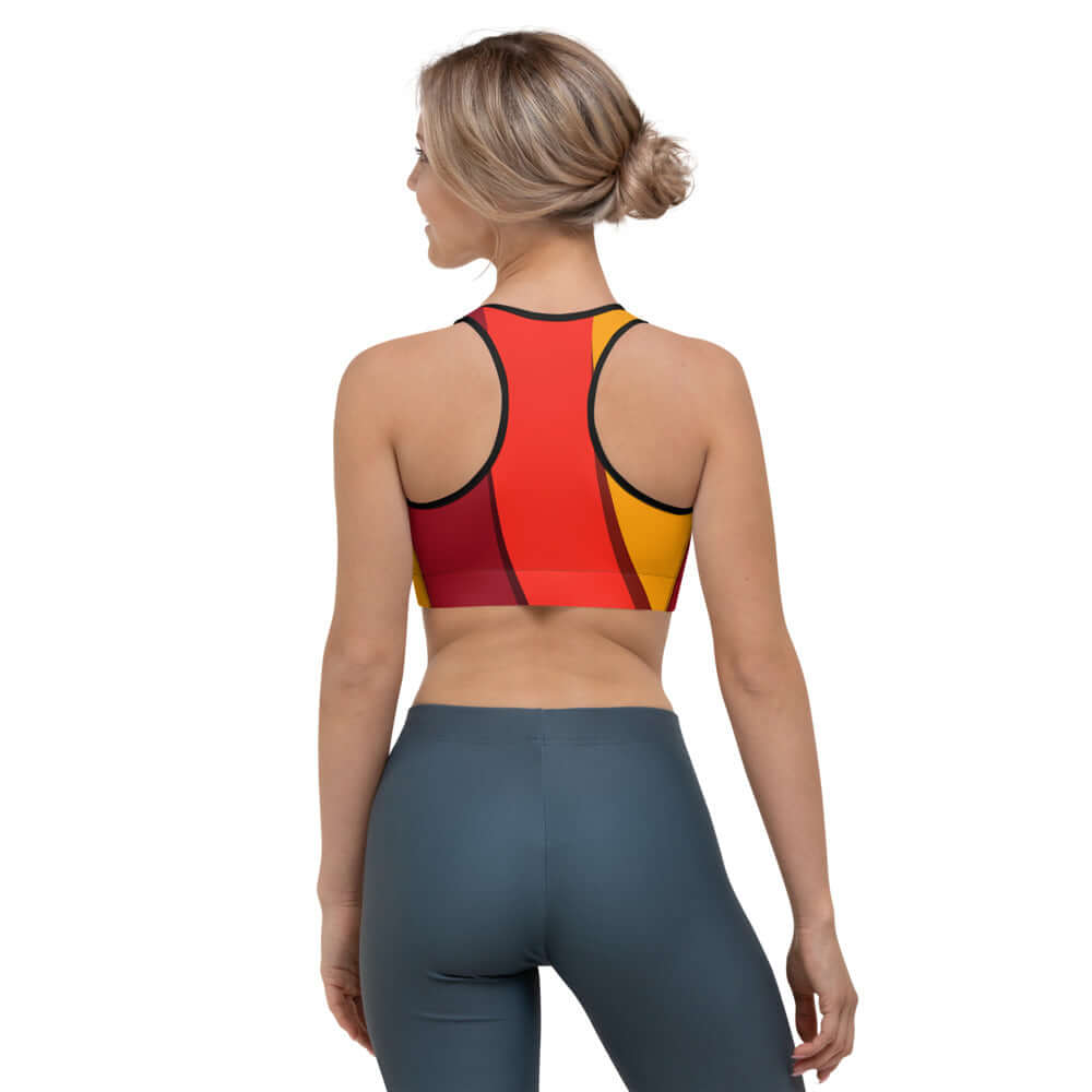Back view of woman wearing Sport-BH N°3 in red and yellow design, showcasing moisture-wicking material for support during workouts.