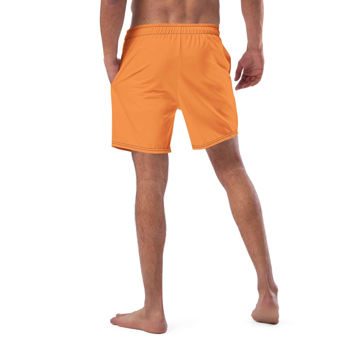Man wearing Herren-Badehosen N°7 in orange, featuring quick-dry fabric and multiple pockets, ideal for summer.