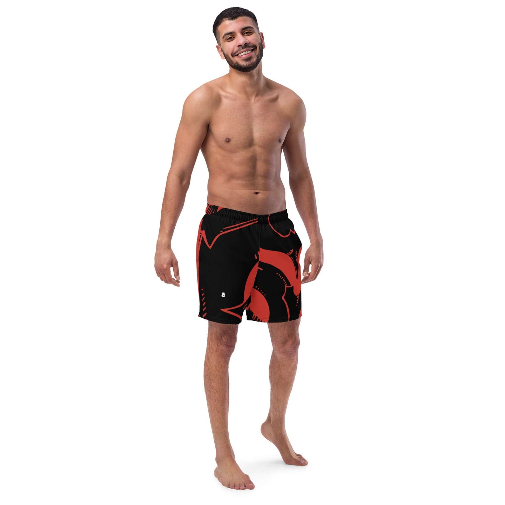 Man wearing Herren-Badehosen N°4 with red and black design, featuring quick-drying and breathable fabric.