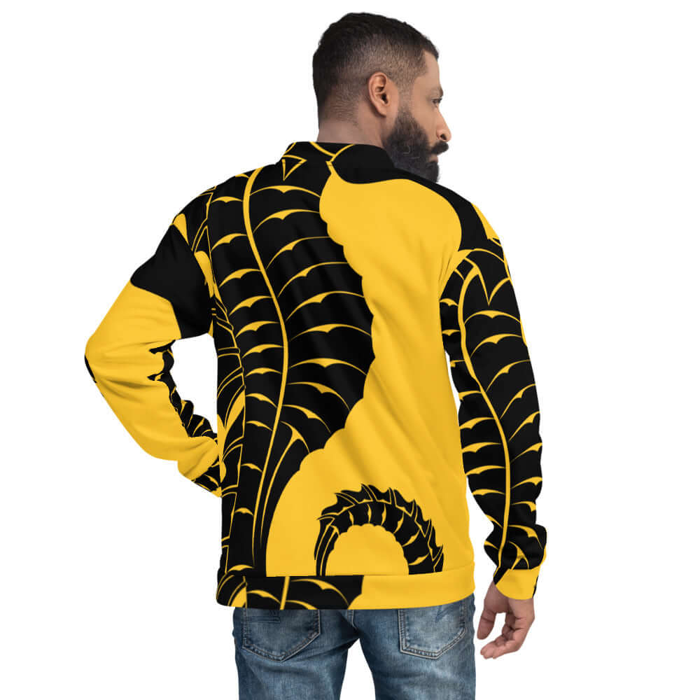 Rear view of model wearing Unisex Bomberjacke N°14 with bold yellow and black graphic design.