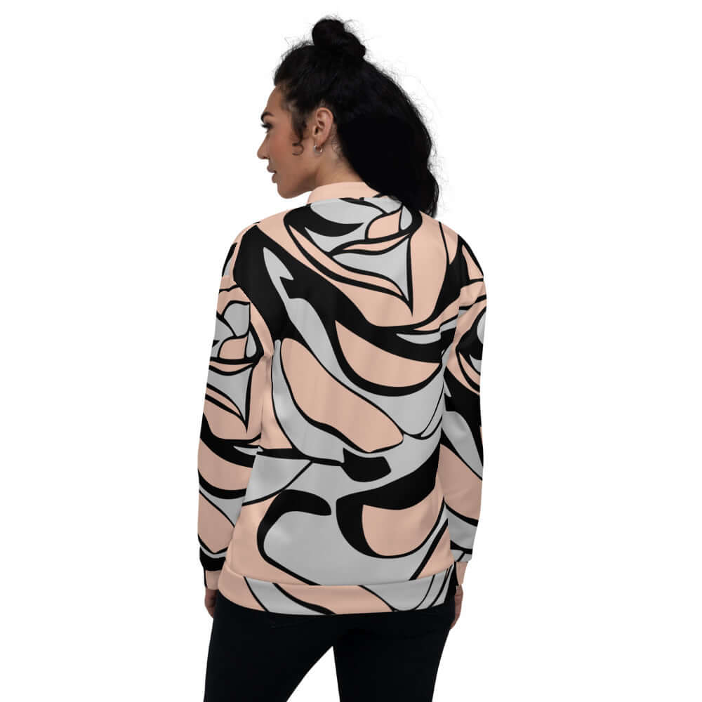 Person wearing Unisex Bomberjacke N°20 with abstract pattern and relaxed fit, highlighting stylish and versatile fashion.