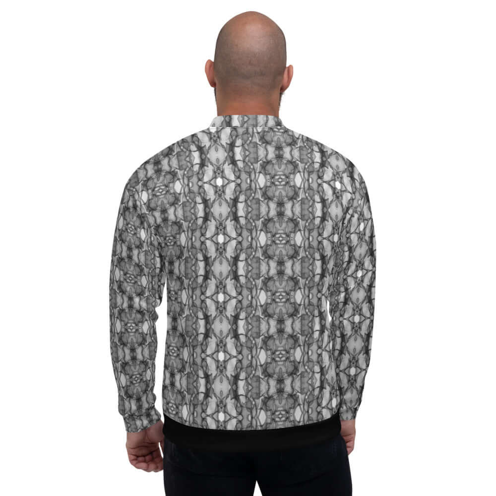 Model wearing the patterned Unisex Bomberjacke N°21, showcasing the back view and relaxed fit.