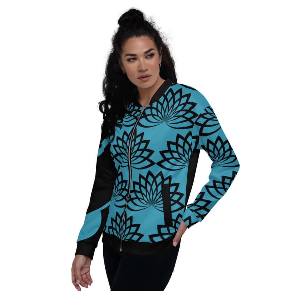 Woman wearing Unisex Bomberjacke N°11 with blue and black lotus print, showcasing versatile fashion style.