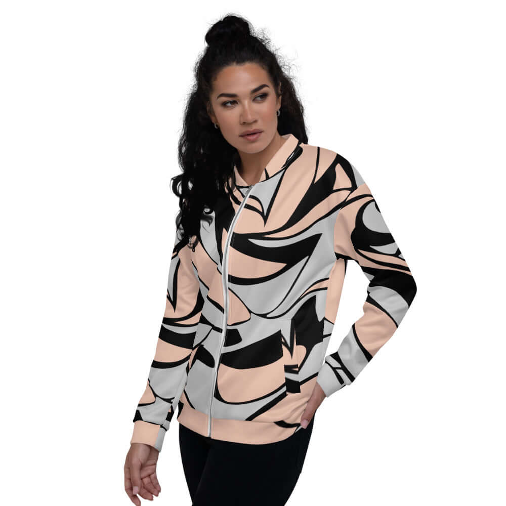 Woman wearing Unisex Bomberjacke N°20 with abstract print, loose fit, highlighting its stylish design and versatility in outfits.