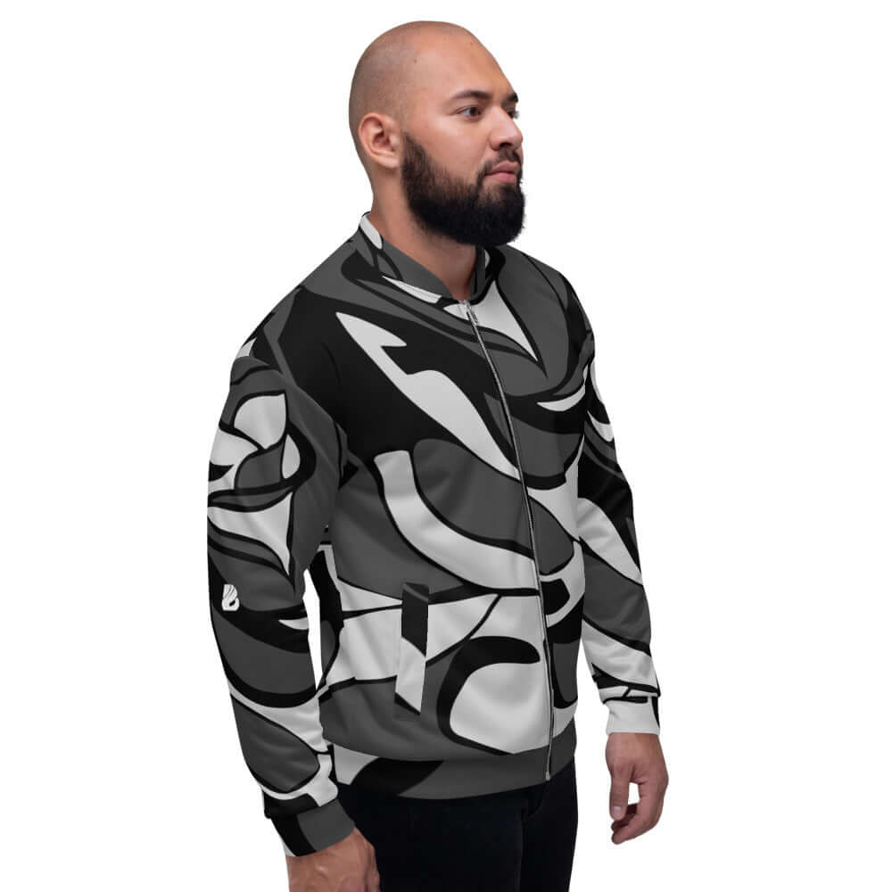Unisex Bomberjacke N°10 in black and white abstract pattern worn by model, featuring fleece interior and loose fit, perfect for any outfit.