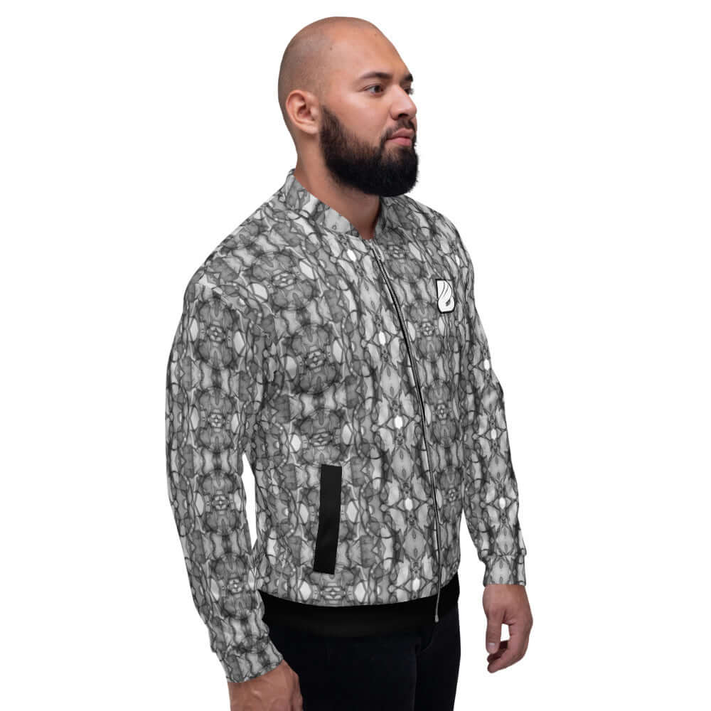 Man wearing Unisex Bomberjacke N°21 with abstract black and white pattern, standing in side view