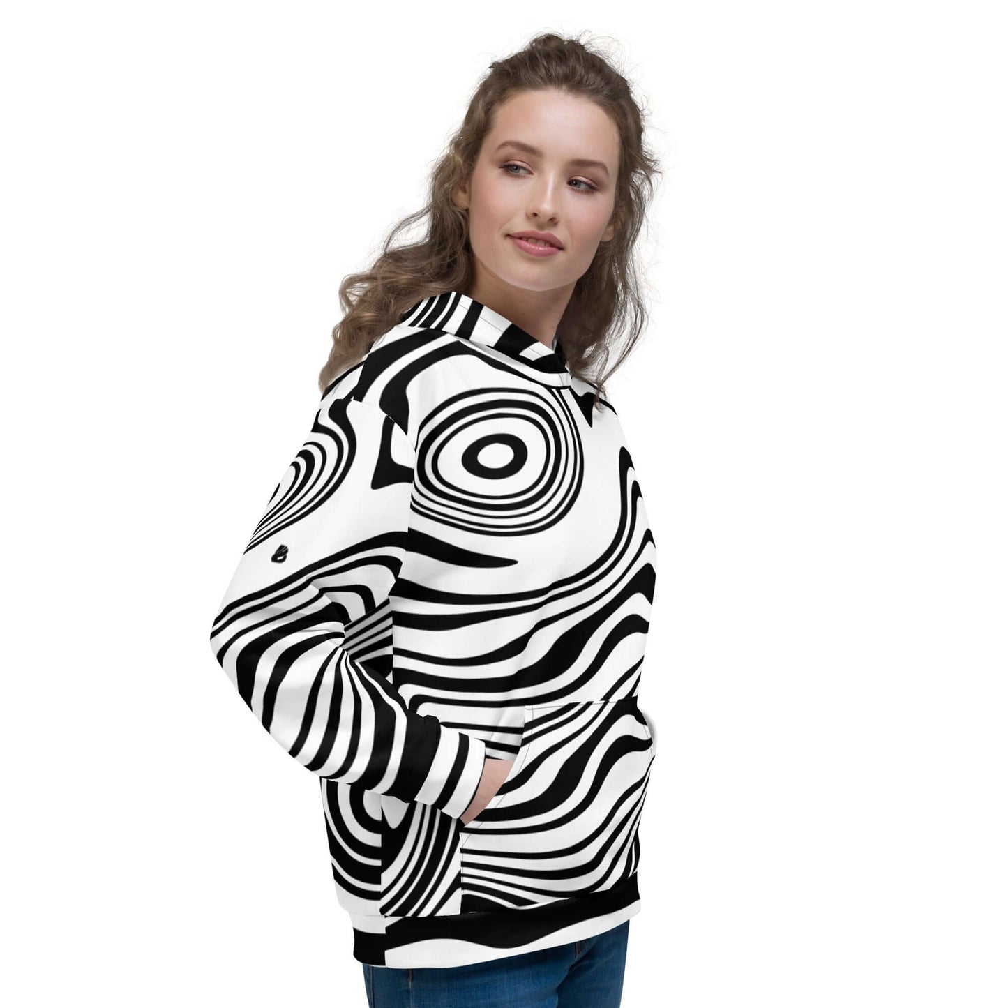 Person wearing Unisex-Kapuzenpullover N°42 with vibrant black and white print, hands in pockets.