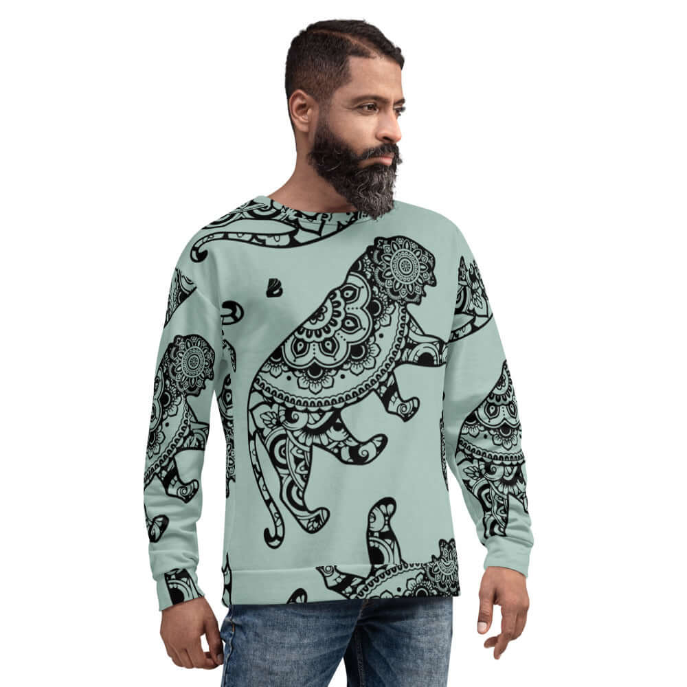 Man wearing Unisex-Pullover N°18 with intricate black animal design on light green background, made from polyester, cotton, and elastane.