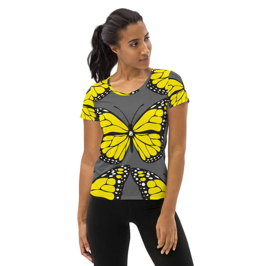 Allover-Sport-T-Shirt für Damen N°3 featuring vibrant yellow butterfly design, moisture-wicking fabric, and antimicrobial properties.
