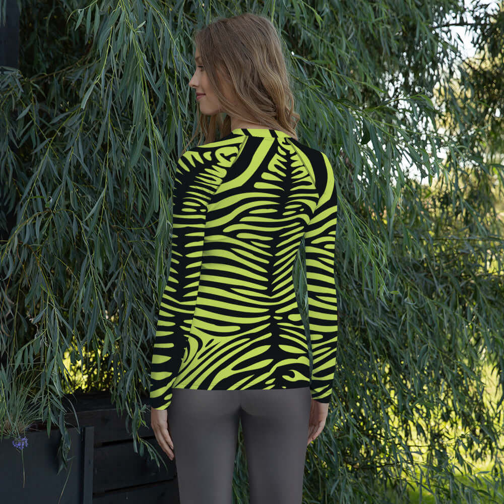 Woman wearing Damen-Rash-Guard N°10 with zebra pattern, long sleeves, providing UV protection and ergonomic fit for outdoor sports.