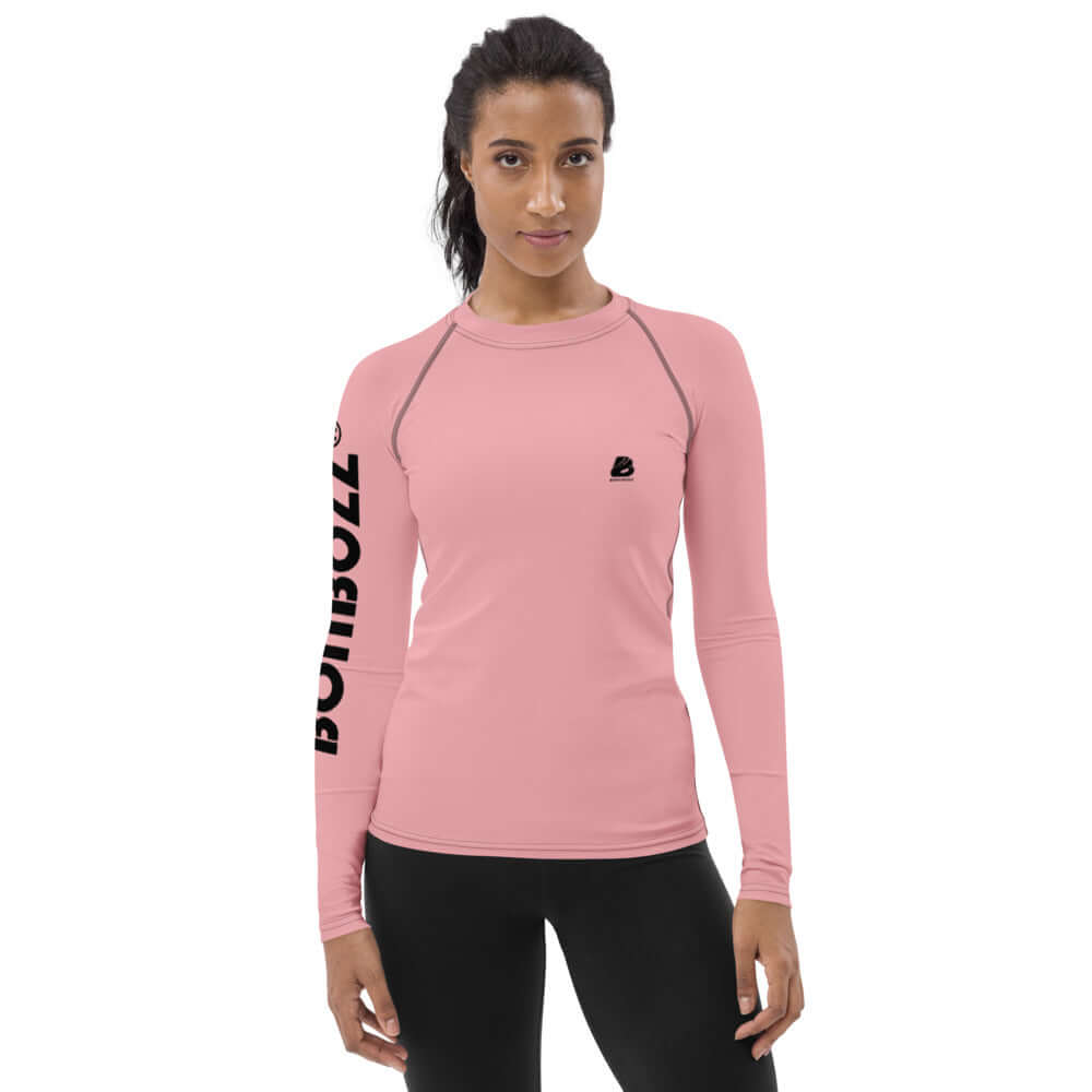 Woman wearing pink Damen-Rash-Guard N°3 with long sleeves and sporty fit, offering sun protection and comfort.